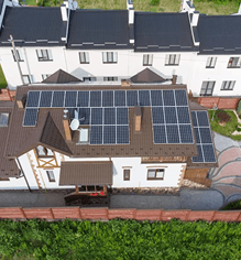 Aerial view of a home with a rooftop solar panel installation