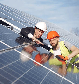 Two Bulldog Solar installers inspecting panels on a rooftop