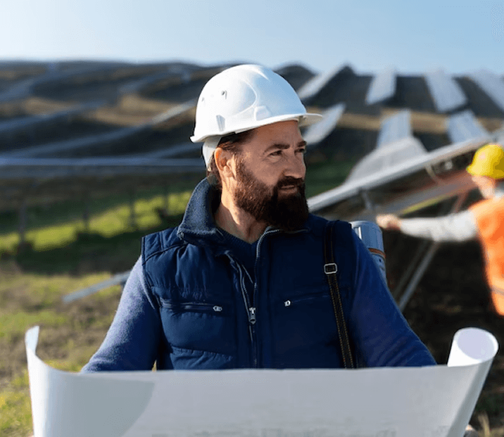 A Bulldog Solar team member reviewing site plans at a solar installation